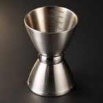 Bell Jigger with Interior Measures, 0.5 to 2 oz, shown on a plain studio background
